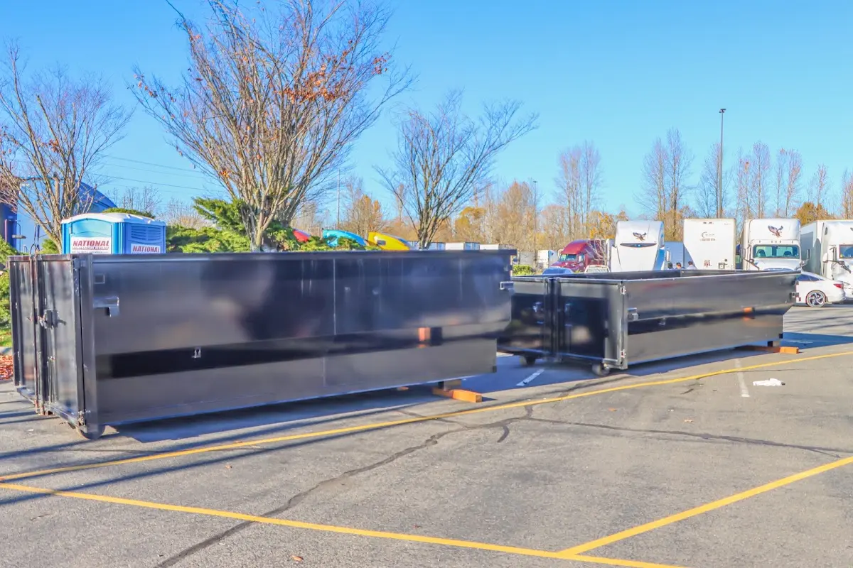 Professional dumpster rental service with roll-off container on residential driveway in Canton